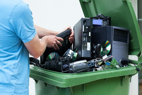 Workers loading mixed commercial waste into a van during a midday job